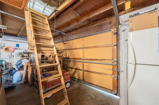 a view of a patio with wooden chairs
