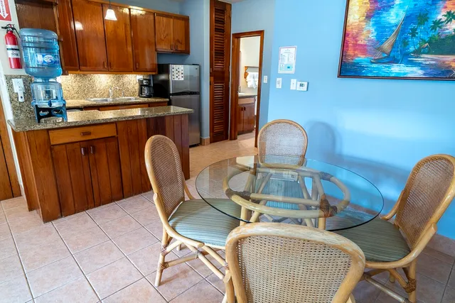 a kitchen with dining area cabinets and chairs