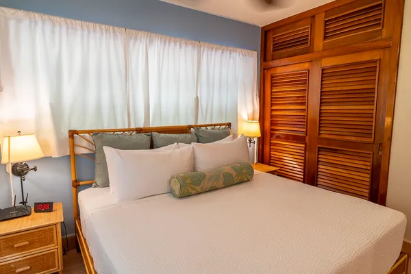 a bed sitting in a bedroom next to a window