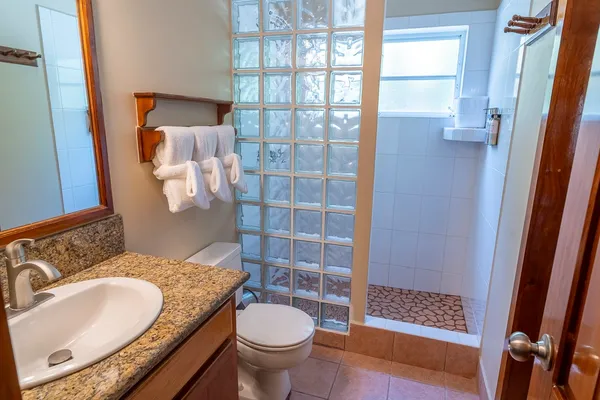 a bathroom with a granite countertop sink and a mirror