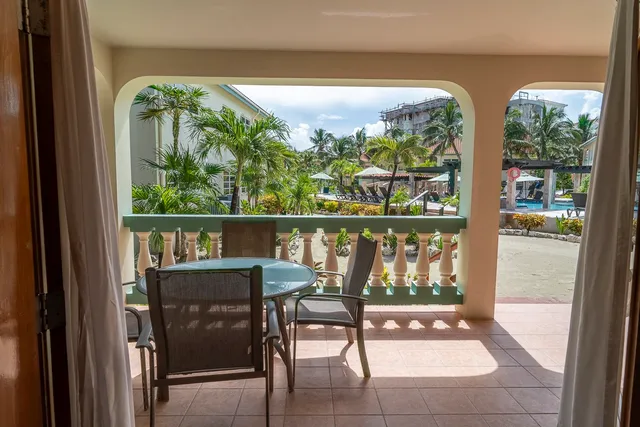 a view of a chairs and table in a balcony