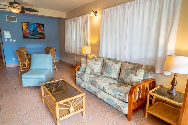 a living room with furniture and a lamp