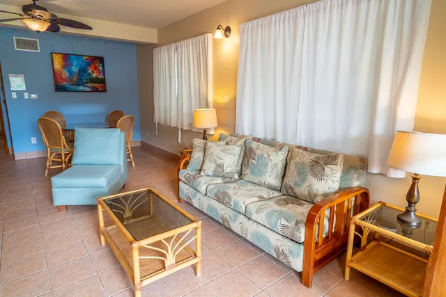 a living room with furniture and a lamp