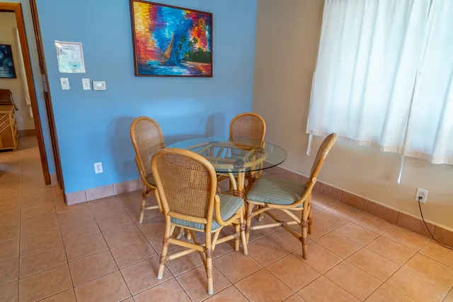 a dining room with furniture and window