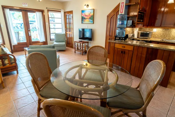 a living room with furniture a flat screen tv and large windows