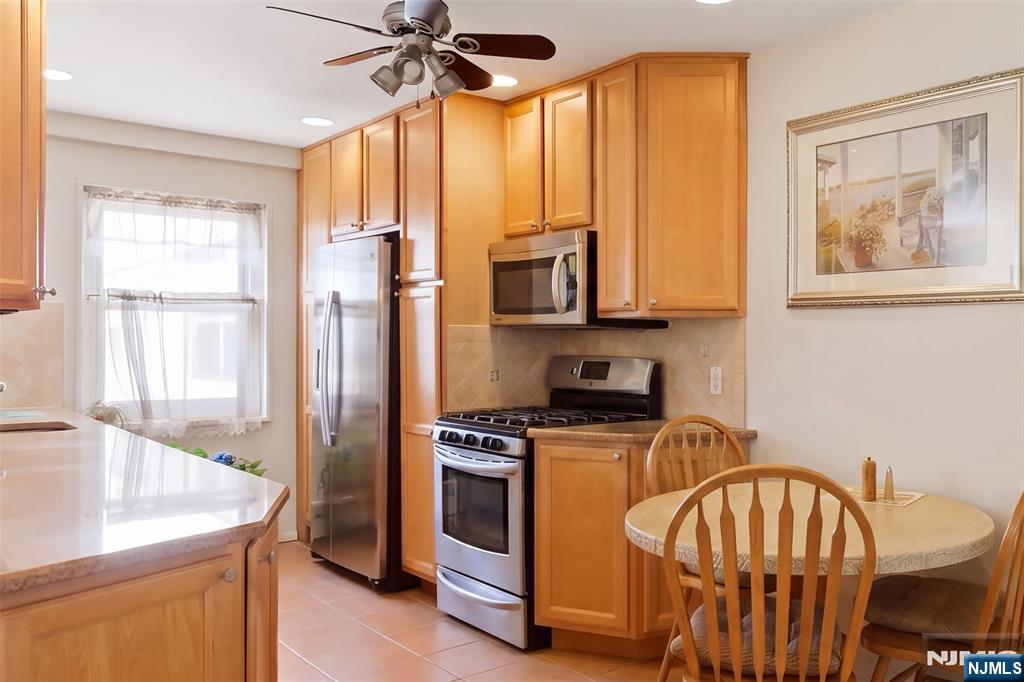 280 Prospect Avenue, Unit 8G Hackensack, NJ 07601 - Photo 9 of 23 a kitchen with stainless steel appliances granite countertop a stove a sink and a refrigerator