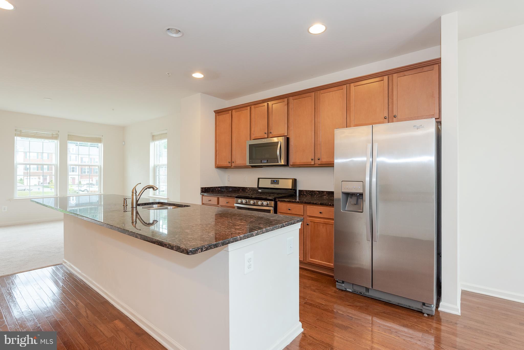 8841 Delegge Road Baltimore, MD 21237 - Photo 14 of 29 a kitchen with stainless steel appliances granite countertop a refrigerator a stove a sink and a microwave