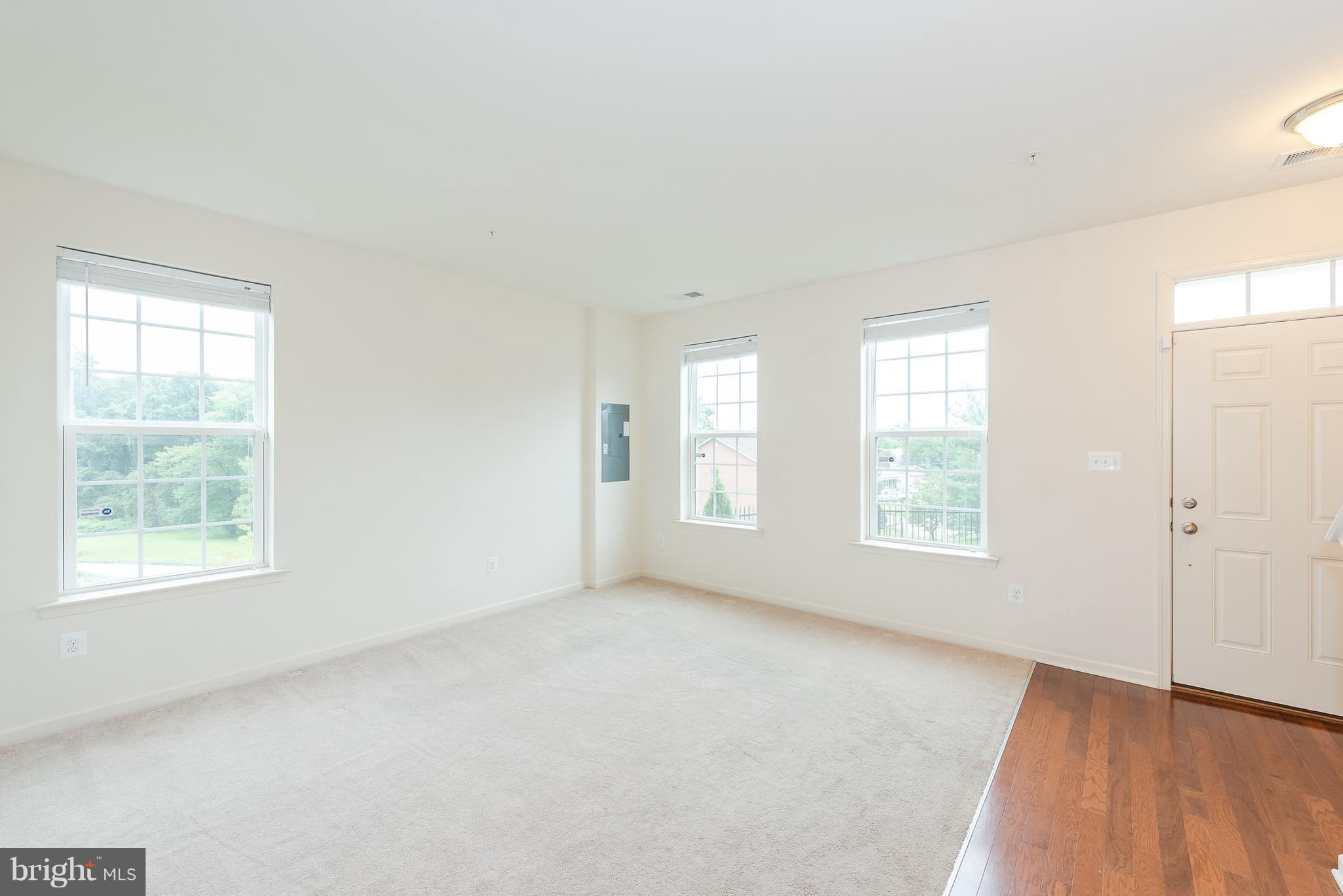 8841 Delegge Road Baltimore, MD 21237 - Photo 3 of 29 an empty room with windows