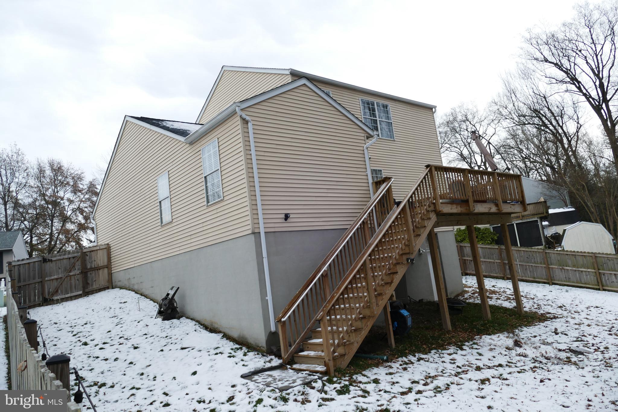 7816 Mallow Court Pasadena, MD 21122 - Photo 23 of 24 Stairs from deck leading to back yard
