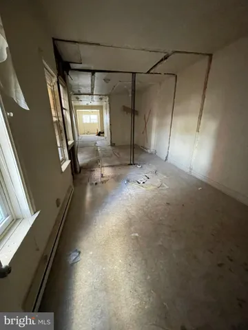 a view of a room with wooden floor and windows