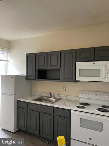 a kitchen with a sink and a stove top oven