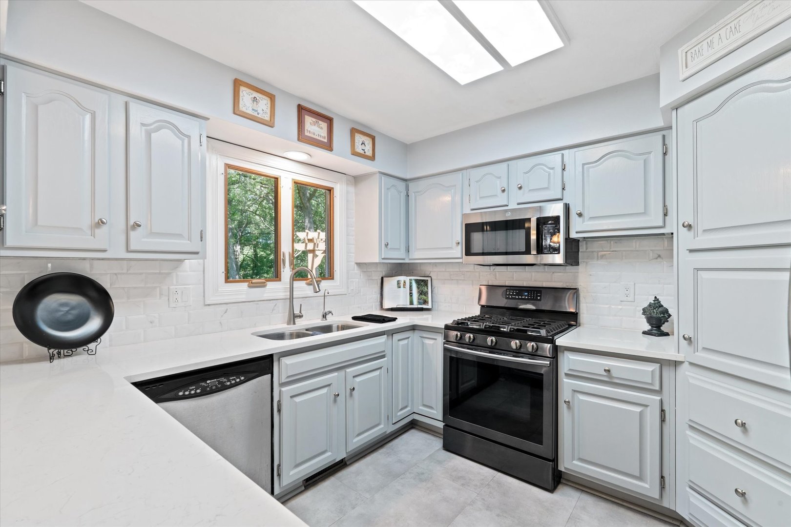 10 Oak Grove Road Geneseo, IL 61254 - Photo 9 of 43 a kitchen with cabinets appliances a sink and a window