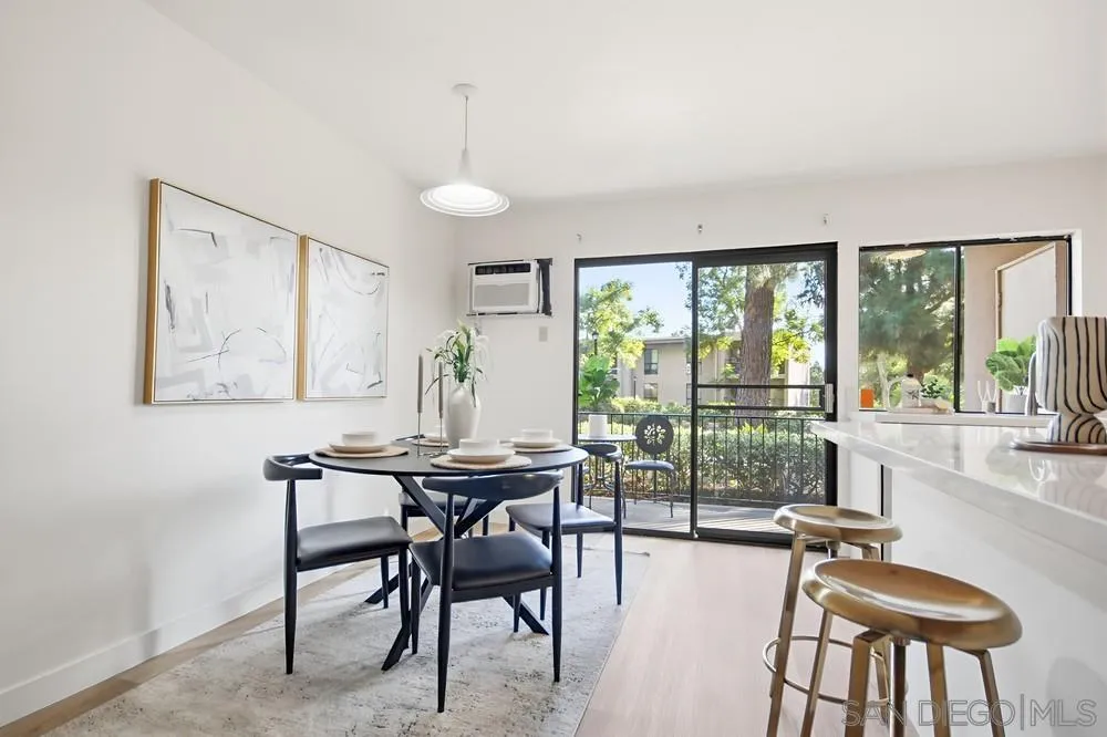 7858 Cowles Mountain Court, Unit D7 San Diego, CA 92119 - Photo 18 of 40 a view of a dining room with furniture and a large window