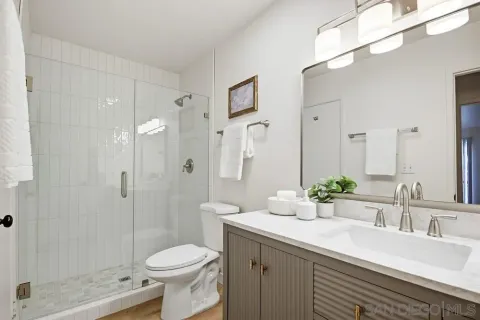 a bathroom with a sink toilet and shower