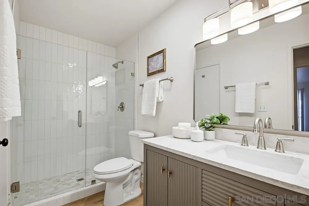 7858 Cowles Mountain Court, Unit D7 San Diego, CA 92119 - Photo 27 of 40 a bathroom with a sink toilet and shower