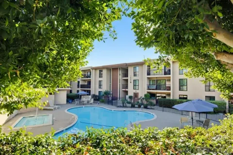 a view of a house with a yard and sitting area