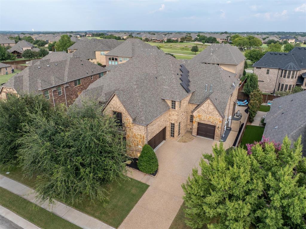 an aerial view of a house with garden space and street view