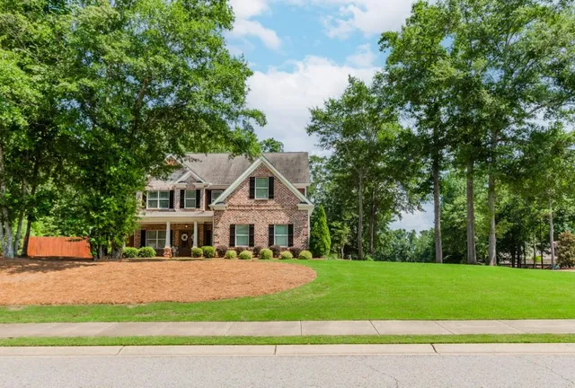 a front view of a house with a yard