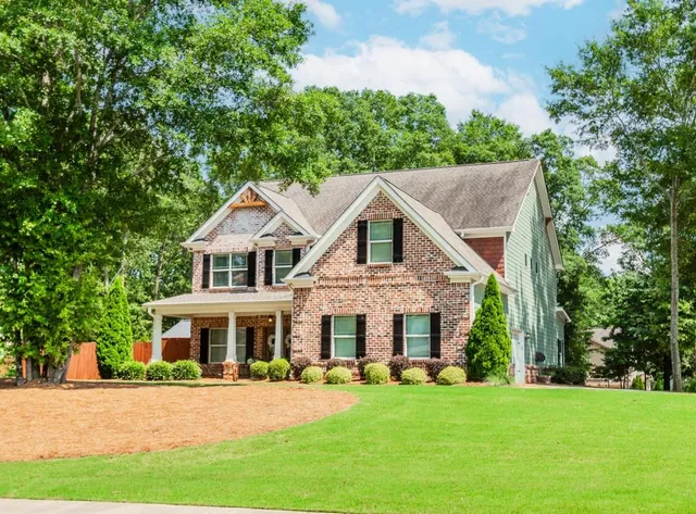 a front view of a house with a yard