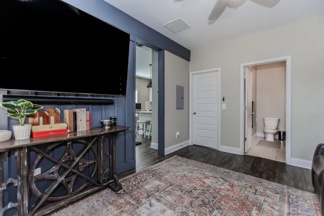 a view of a patio with table and chairs potted plants with floor to ceiling window