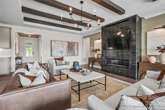 a kitchen with stainless steel appliances a sink a stove a refrigerator cabinets and living room view