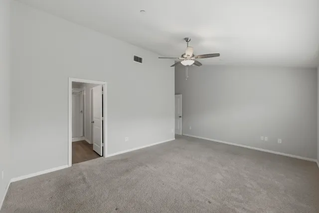 a bathroom with a double vanity sink toilet mirror and shower