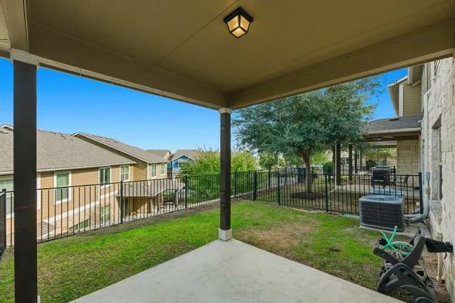 a view of a house with backyard and porch