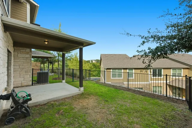 a view of a house with a yard and sitting area