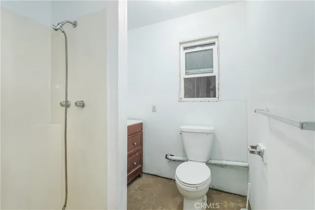 a white toilet sitting next to a bathroom sink