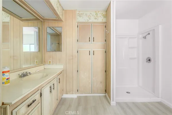 a bathroom with a sink a mirror and a shower