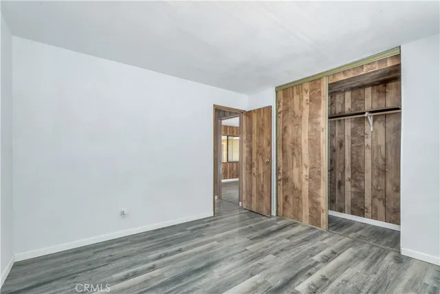 an empty room with wooden floor and a window