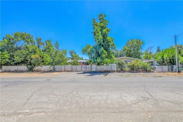 a backyard of a house with lots of green space and trees