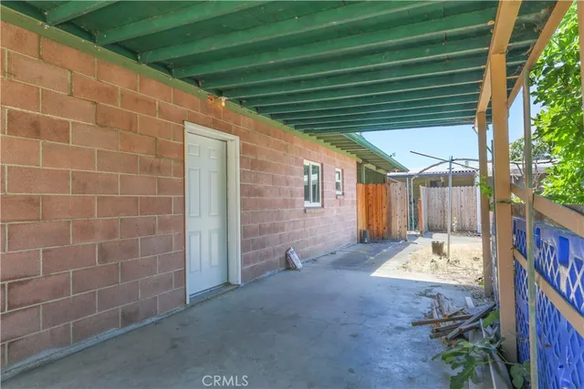 a view of a porch with furniture and a yard