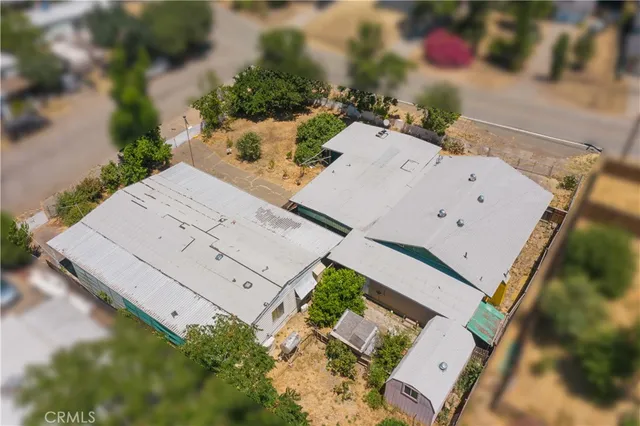 an aerial view of a house with a yard and garden