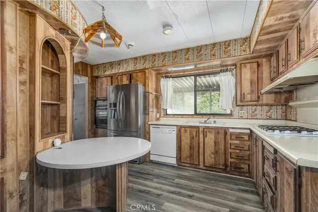 a kitchen with stainless steel appliances a sink and a window