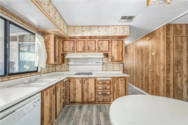 a kitchen with stainless steel appliances a sink and cabinets