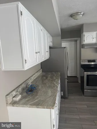 a kitchen with a sink and a refrigerator