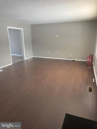 an empty room with wooden floor