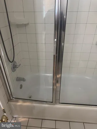 a bathroom with a glass shower door