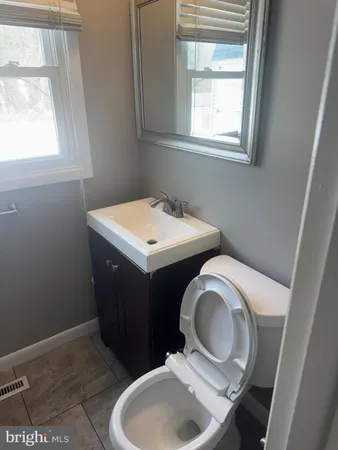 a bathroom with a toilet sink and mirror