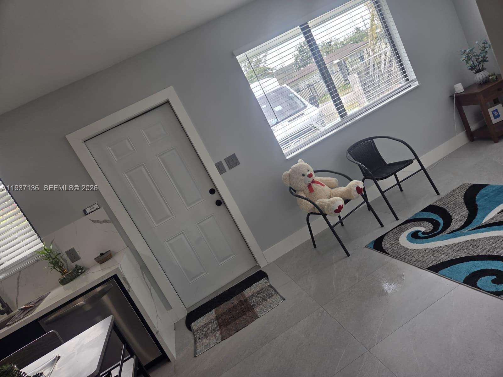 2979 Northwest 88th Street, Unit 1 Miami, FL 33147 - Photo 2 of 7 a view of an entryway with wooden floor