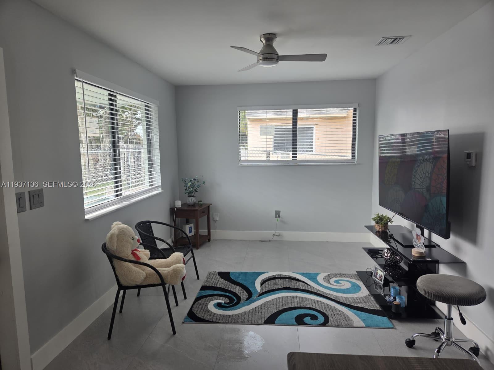2979 Northwest 88th Street, Unit 1 Miami, FL 33147 - Photo 3 of 7 a view of a workspace with furniture and a window