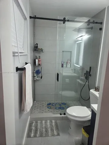 a bathroom with a toilet and a shower