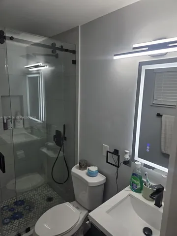 a bathroom with a toilet and a shower