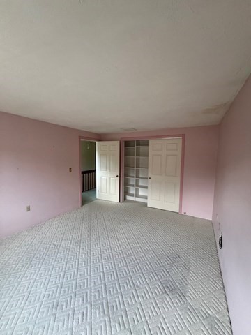 920 Ridgefield Circle, Unit C Clinton, MA 01510 - Photo 16 of 26 a view of an empty room with a window and wooden floor