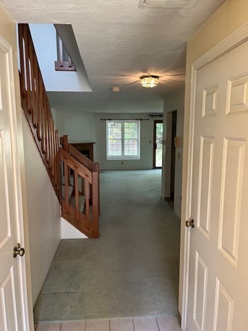 920 Ridgefield Circle, Unit C Clinton, MA 01510 - Photo 3 of 26 a view of a hallway with wooden floor and staircase