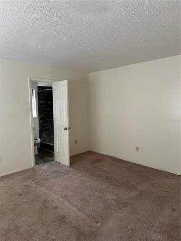 a bathroom with a granite countertop toilet sink and mirror