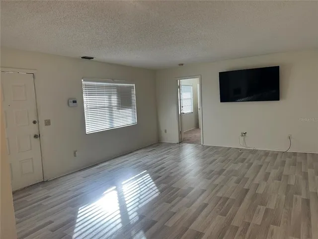 an empty room with an entrance to other room