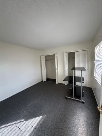 a bathroom with a granite countertop toilet a sink and a mirror