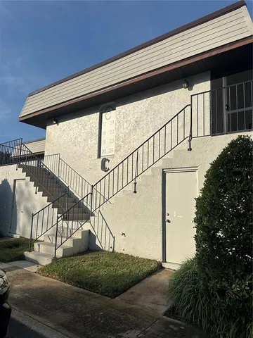 a view of a hallway with wooden floor and fence
